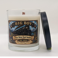 Candle with a label featuring Big Boy design. Earthy, fruity, floral, fresh. Shown with lid.