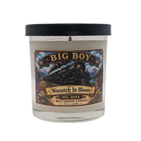 Candle with a label featuring 'Big Boy' and 'Wasatch in Bloom' on a white background.  Floral, fresh, earthy