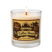 An 8 oz glass jar candle with a lit wick, featuring a cream-colored wax and a decorative label that reads 'Coffee House' with illustrations of coffee beans and mugs. The brand 'Red Caboose Candles' is visible on the label.