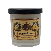 An 8 oz glass jar candle with a black lid and a vintage-style label reading 'Sugared Lemon' by Red Caboose Candles  shown on a plain white background.